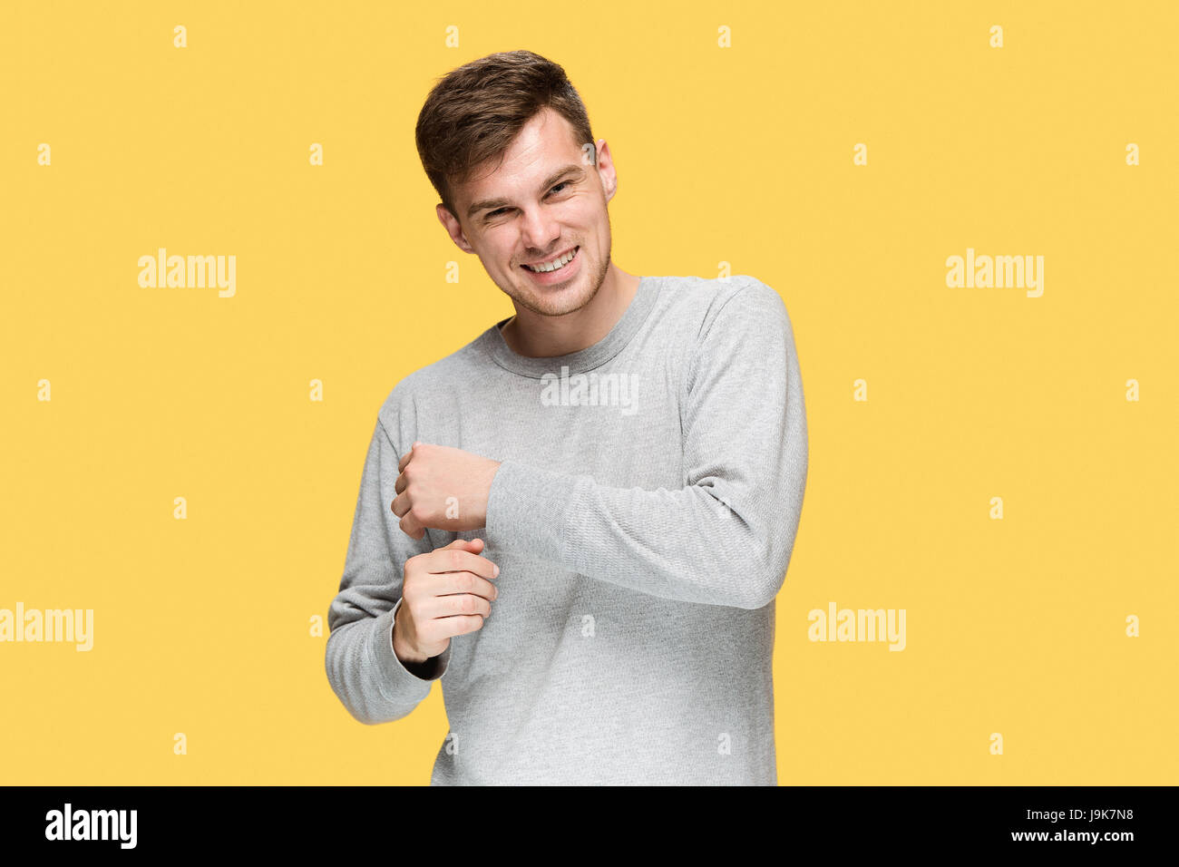 The young man smiling and looking at camera Stock Photo - Alamy