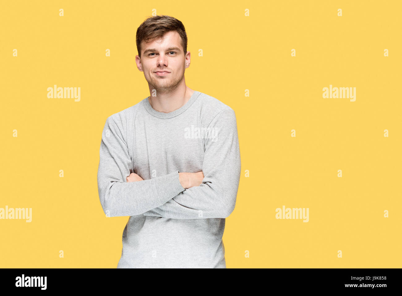 The young man smiling and looking at camera Stock Photo - Alamy
