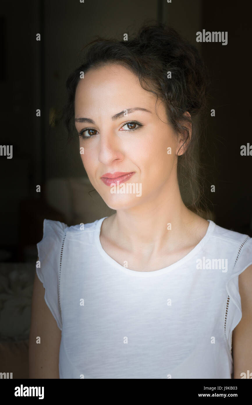 Portrait of a woman of 31 years old with updo hair, looking at camera in a confident way, caucasian, greek. Stock Photo