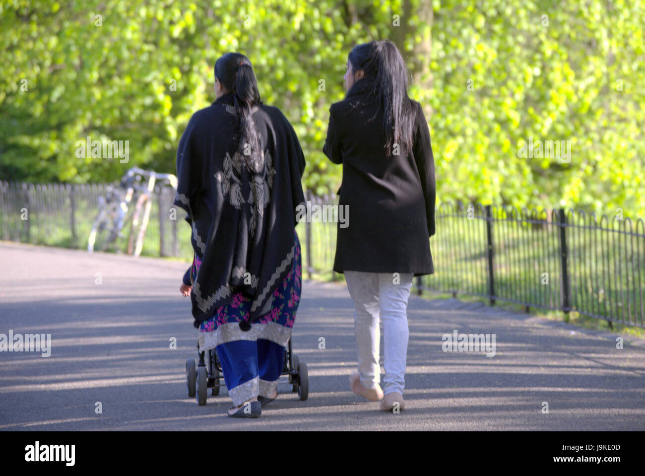 Glasgow Kelvingrove park scenes Asians walking sunny Stock Photo
