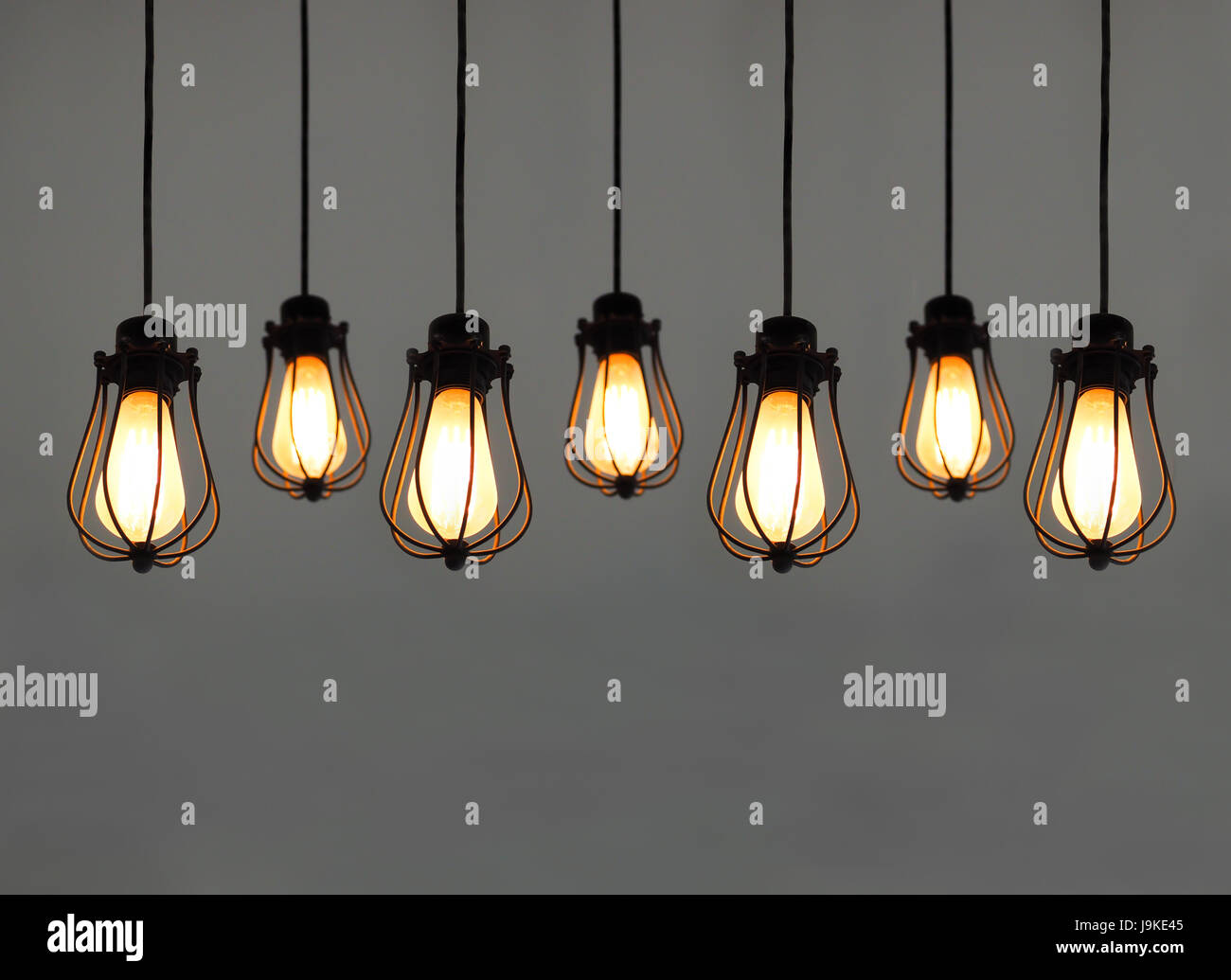 Beautiful hanging light bulbs on plain background for card, banner,  wallpaper Stock Photo - Alamy
