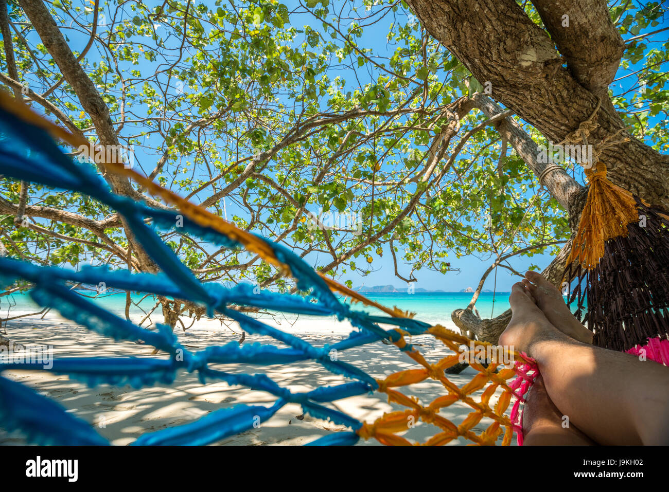 Man sleep Hammock Tree Straps hang over the beach under shade, on day time wide shot background at Nyaung Oo Phee, Myanma Stock Photo