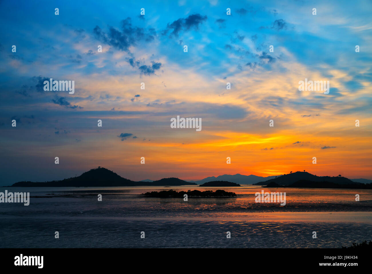 Nice sunset over sea and silhouette mountain twilight time  wide shot background Stock Photo