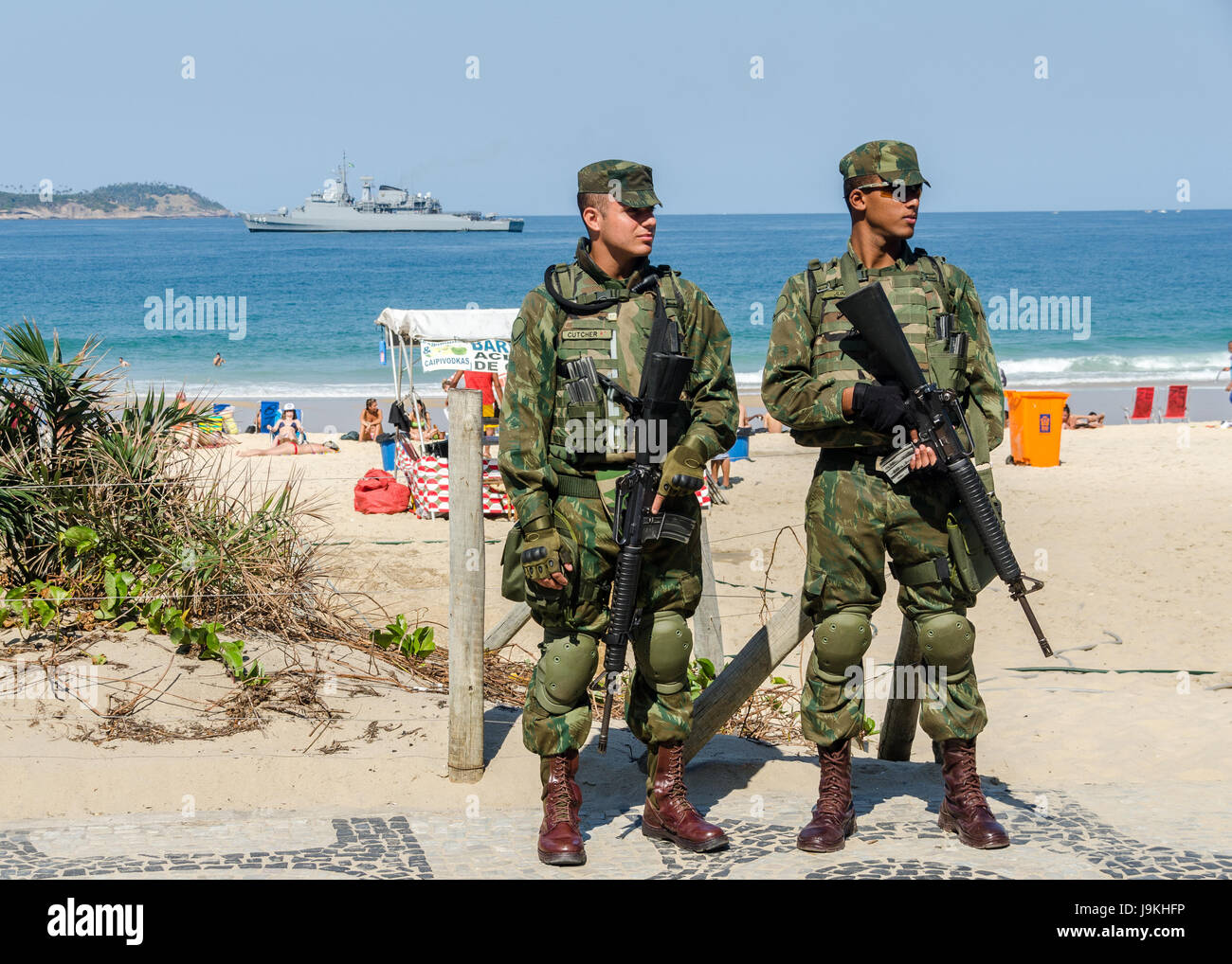 Brazilian army police in camo fatigues patrol the beach in Ipanema as the city steps up security in preparation for the Olympics Stock Photo