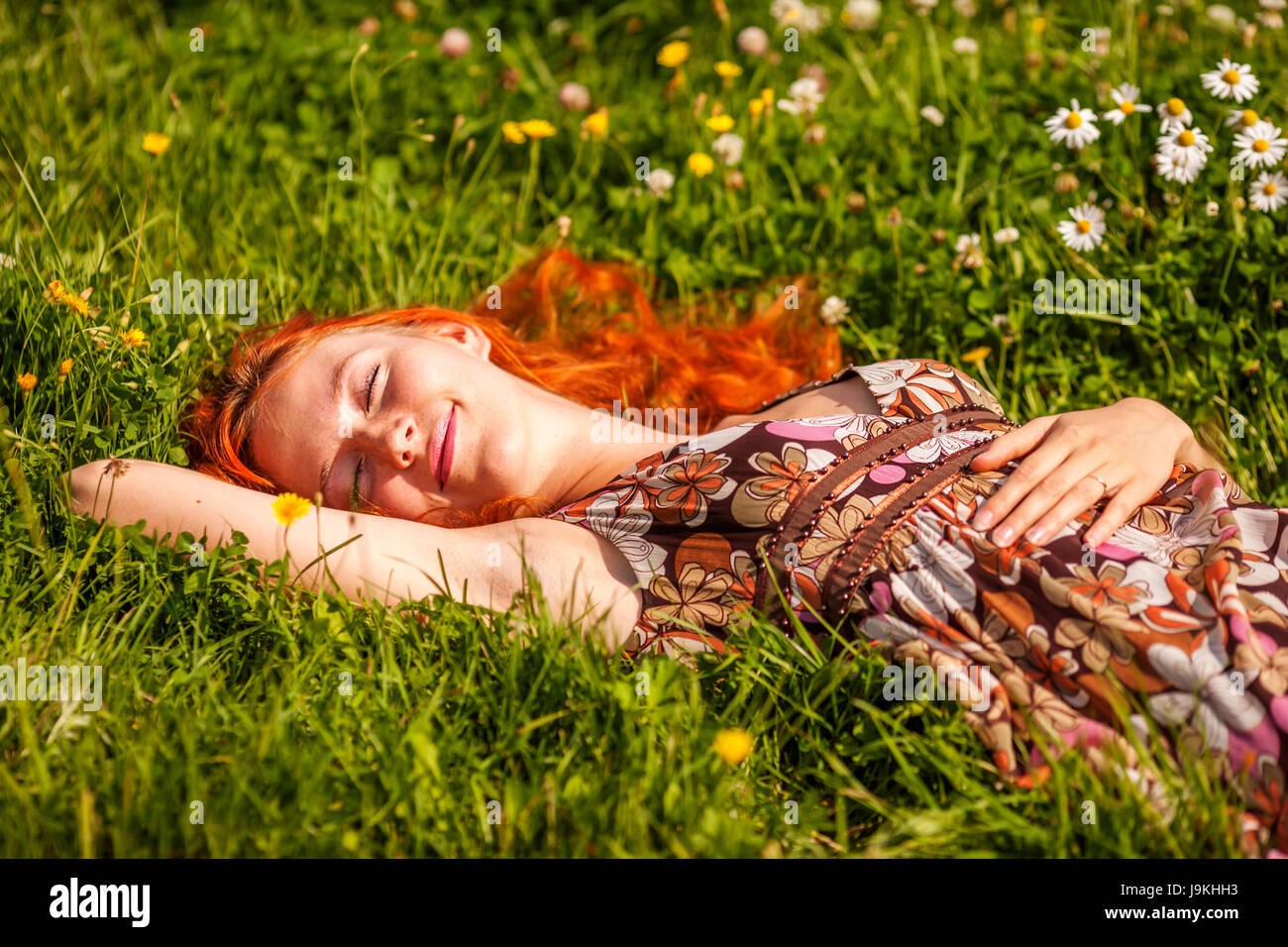 Young woman lying in grass dreaming summer day Stock Photo - Alamy