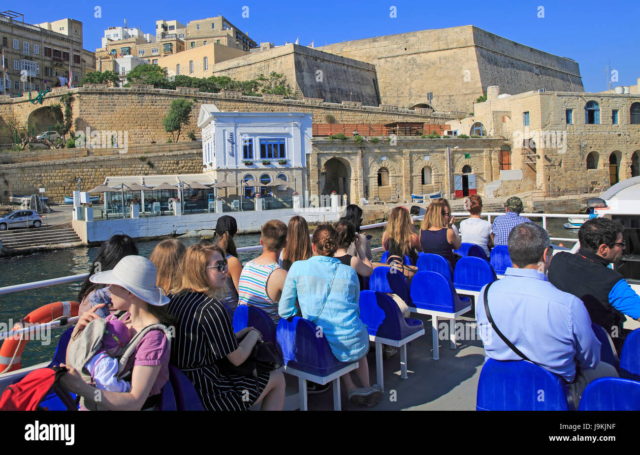 People onboard ferry boat crossing harbour from Sliema to Valletta, Malta Stock Photo