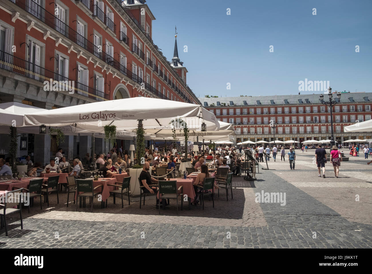 Tourists eating and drinking at a cafe in Plaza Major, Madrid, Spain Stock Photo