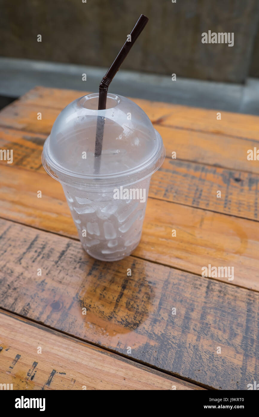 A glass of ice cubes on wooden Stock Photo - Alamy