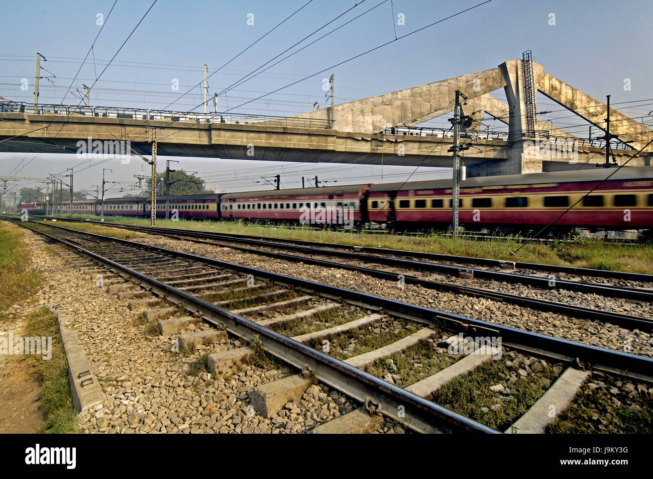 Metro Rail on bridge above railway tracks, Delhi, India, Asia Stock