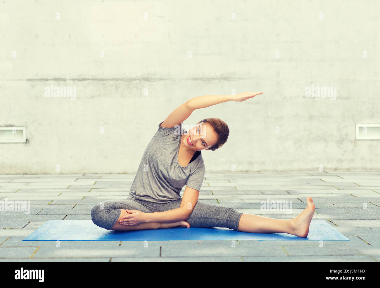 happy woman making yoga and stretching on mat Stock Photo - Alamy
