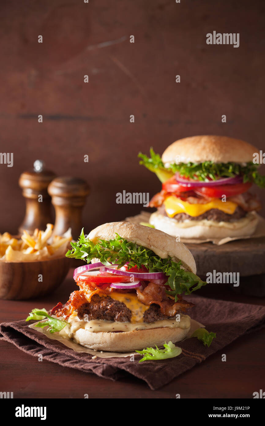 bacon cheese burger with beef patty, tomato and onion Stock Photo