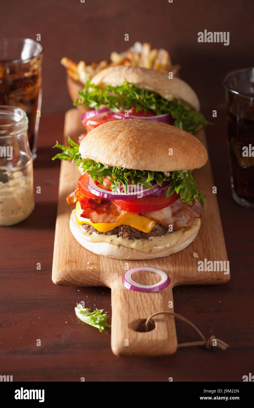 bacon cheese burger with beef patty, tomato and onion Stock Photo