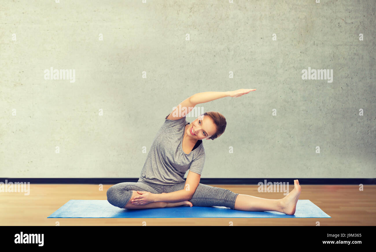 happy woman making yoga and stretching on mat Stock Photo - Alamy