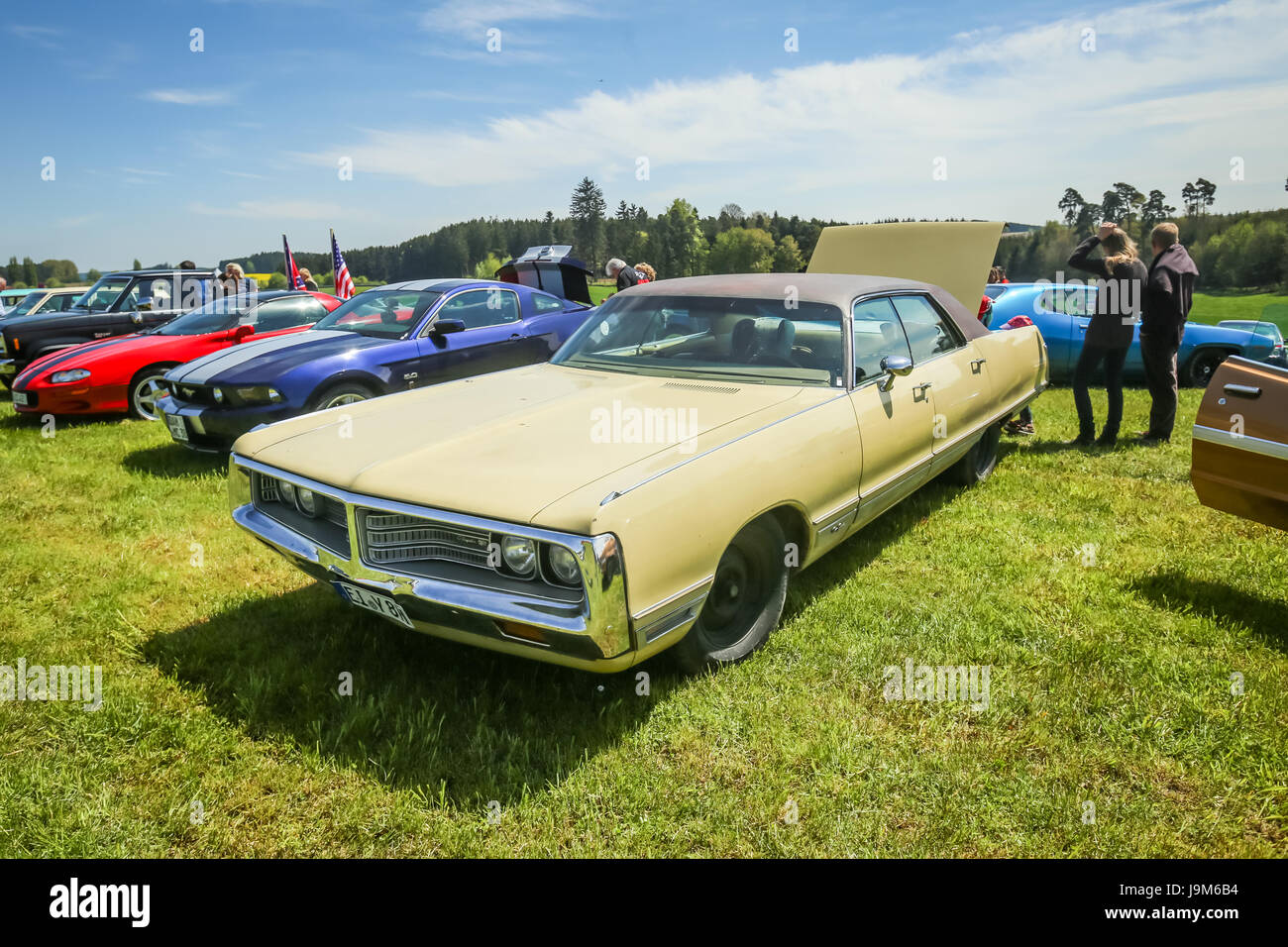 NANDLSTADT, GERMANY - MAY 6, 2017 : People sightseeing american automobile Chrysler displayed at the US Car meeting in Nandlstadt, Germany. Stock Photo
