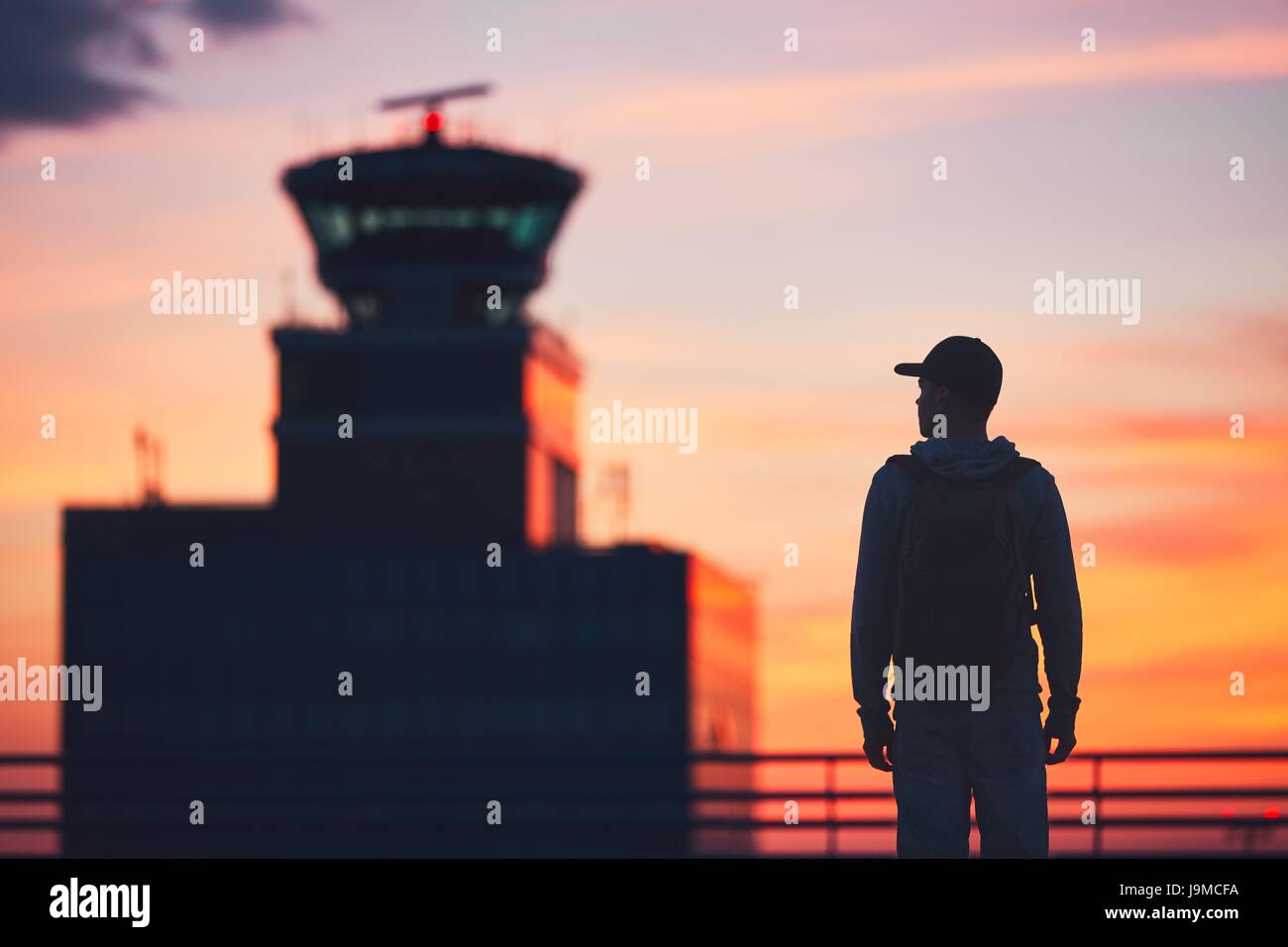 Silhouette of the traveler at the airport. Air Traffic Control Tower at ...