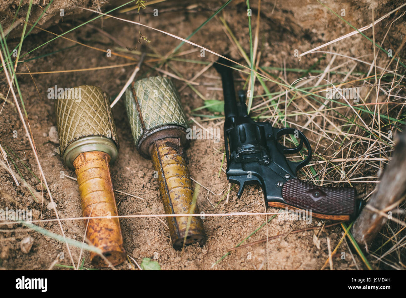 Soviet Red Army Russian Soldiers Military Ammunition Of World War II On Ground. Two Grenades And Nagant Handgun Gun. Stock Photo