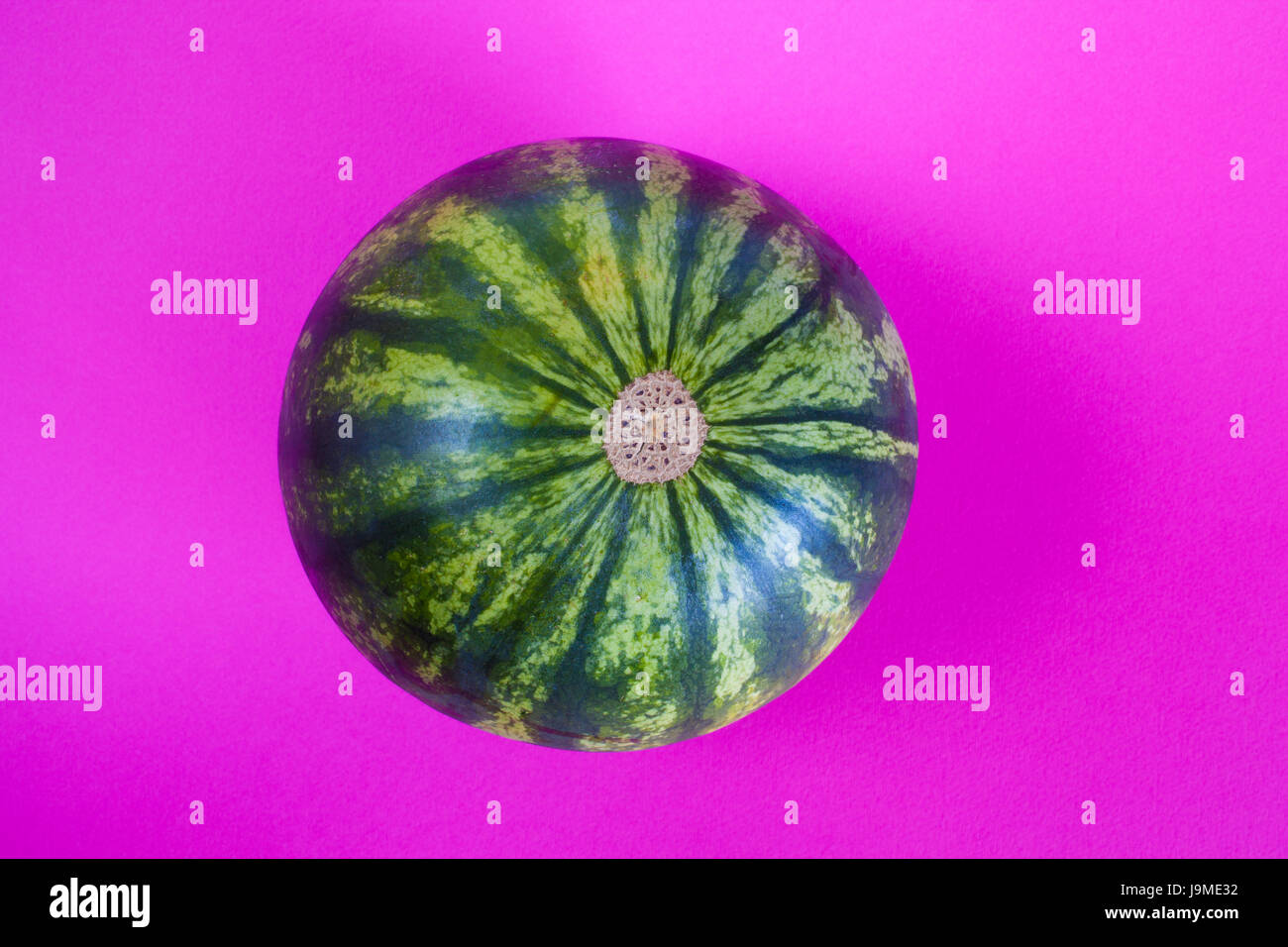 whole watermelon top view on purple background. Stock Photo