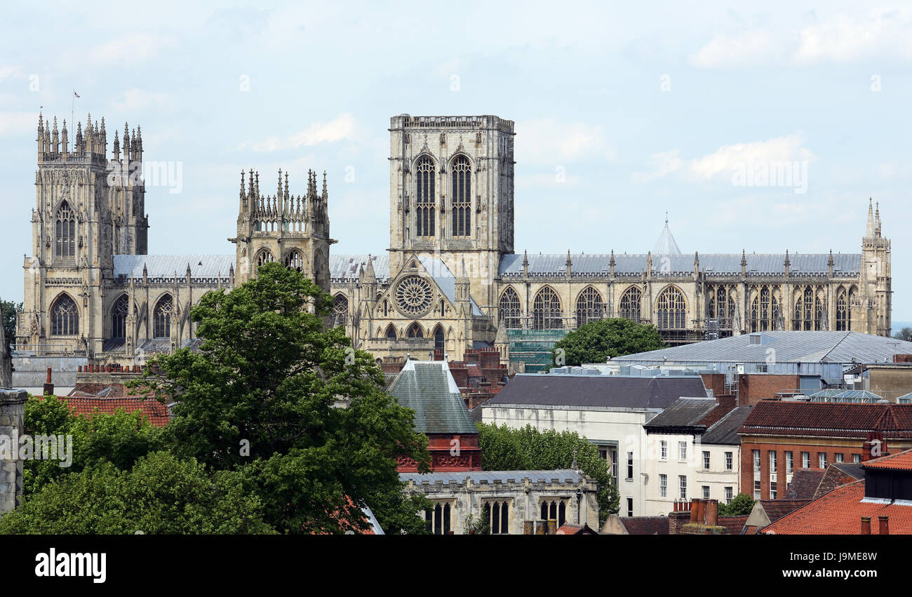 York Minster in the UK, looking over rooftops in the foreground. Stock Photo