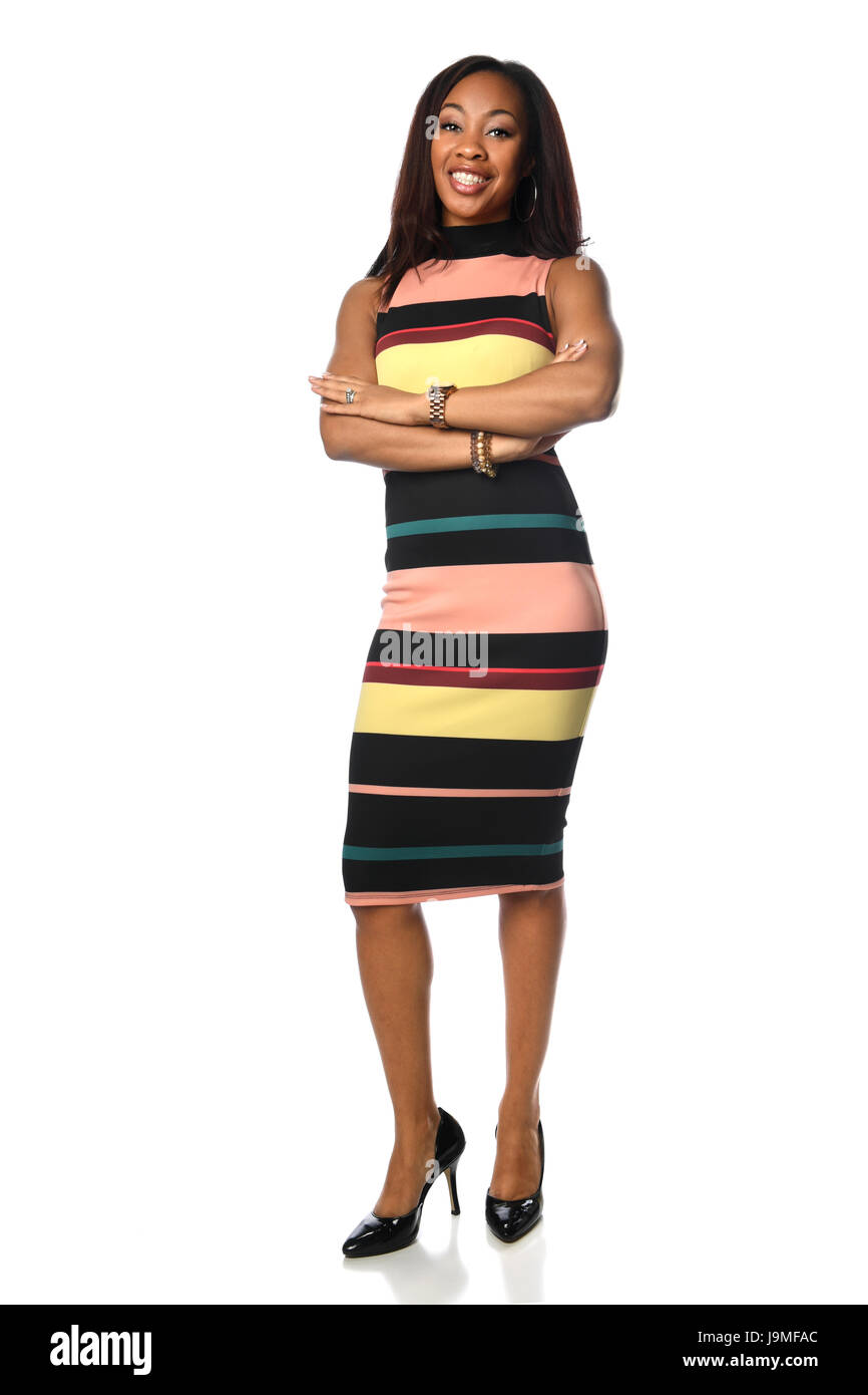 Young African American businesswoman standing with arms crossed ...
