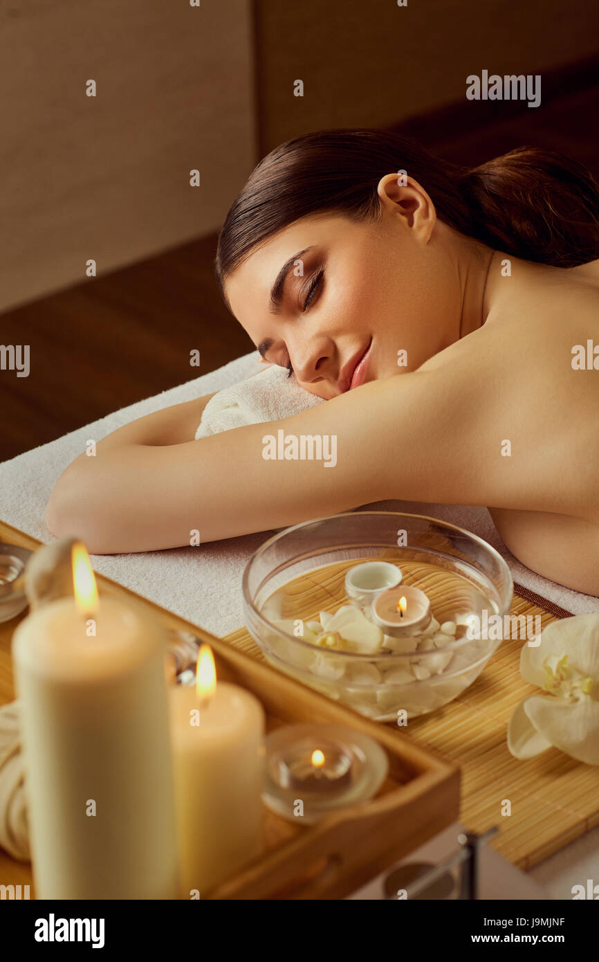 Beautiful woman relaxing lying down in spa salon. Stock Photo