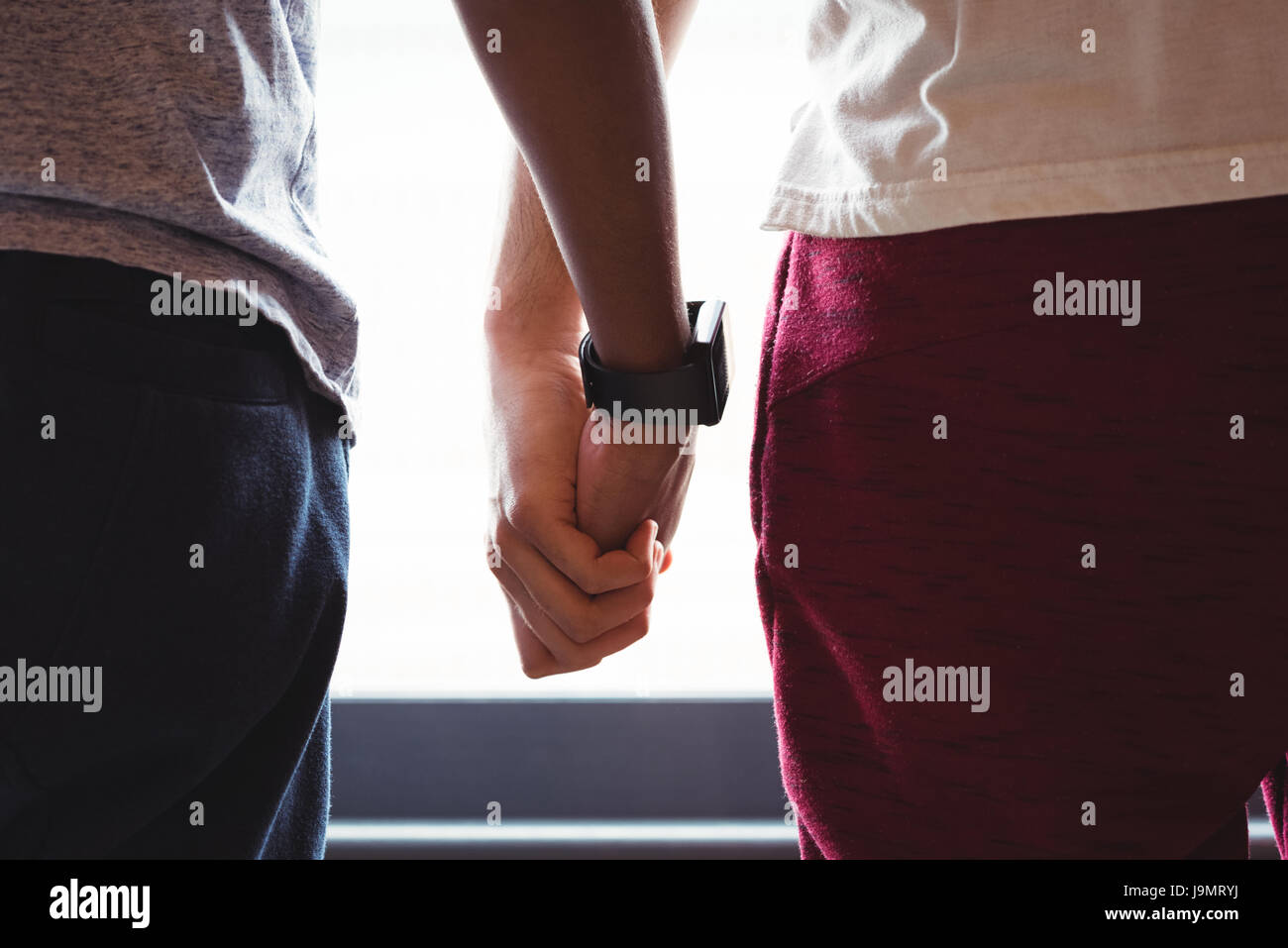Close up of gay couple holding hands Stock Photo - Alamy