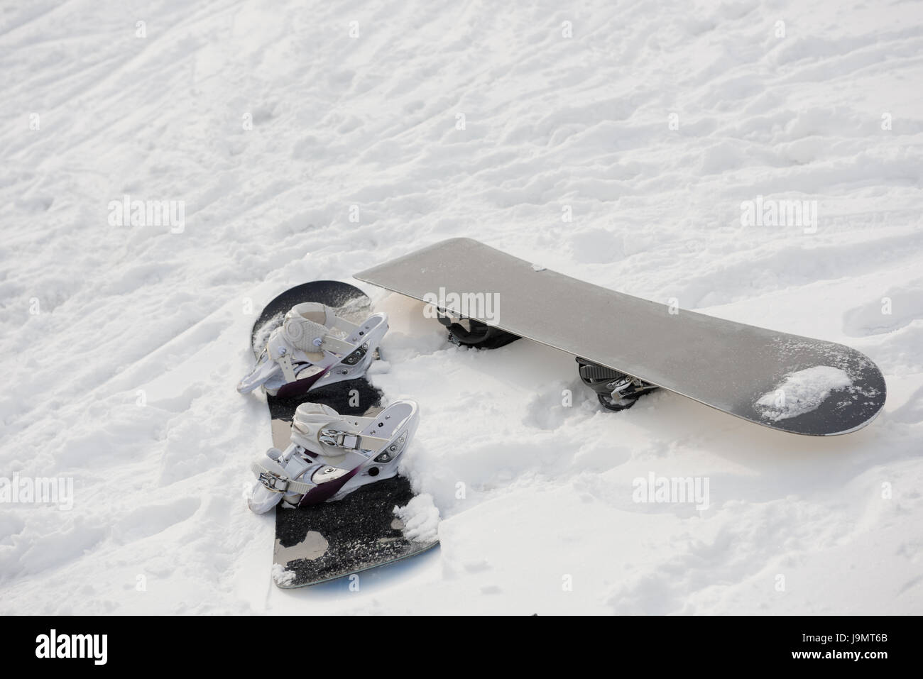 Snowboard on snowy slope in ski resort during winter Stock Photo