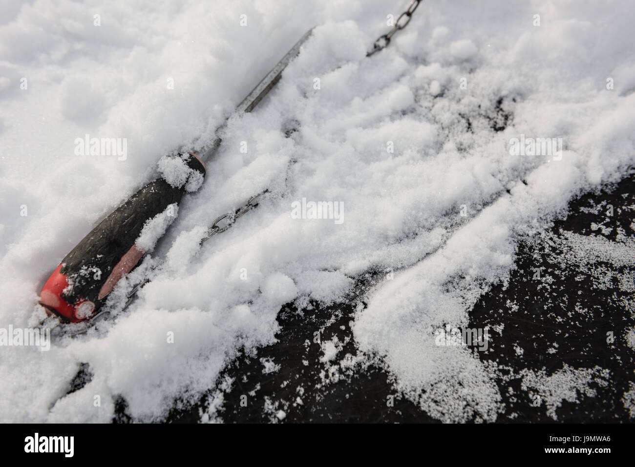Close-up of screwdriver covered with snow during summer Stock Photo