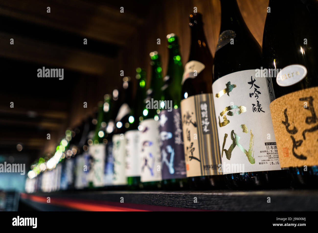 A line of sake bottles on store display Stock Photo Alamy