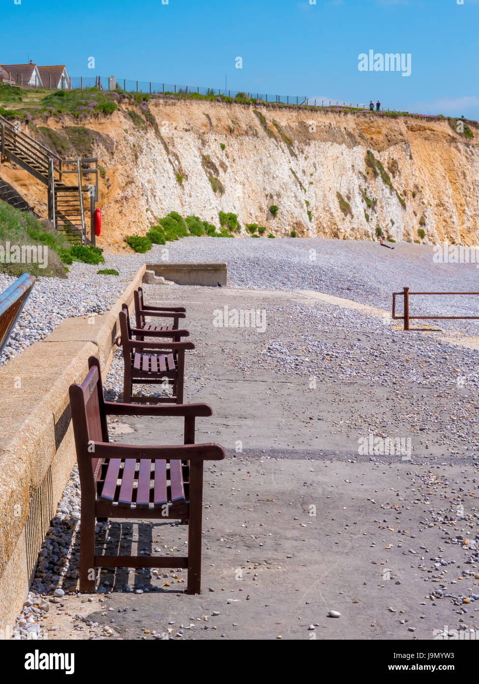 Benches on beach of Isle of Wight in summer, England, UK. Focus on firts bench Stock Photo