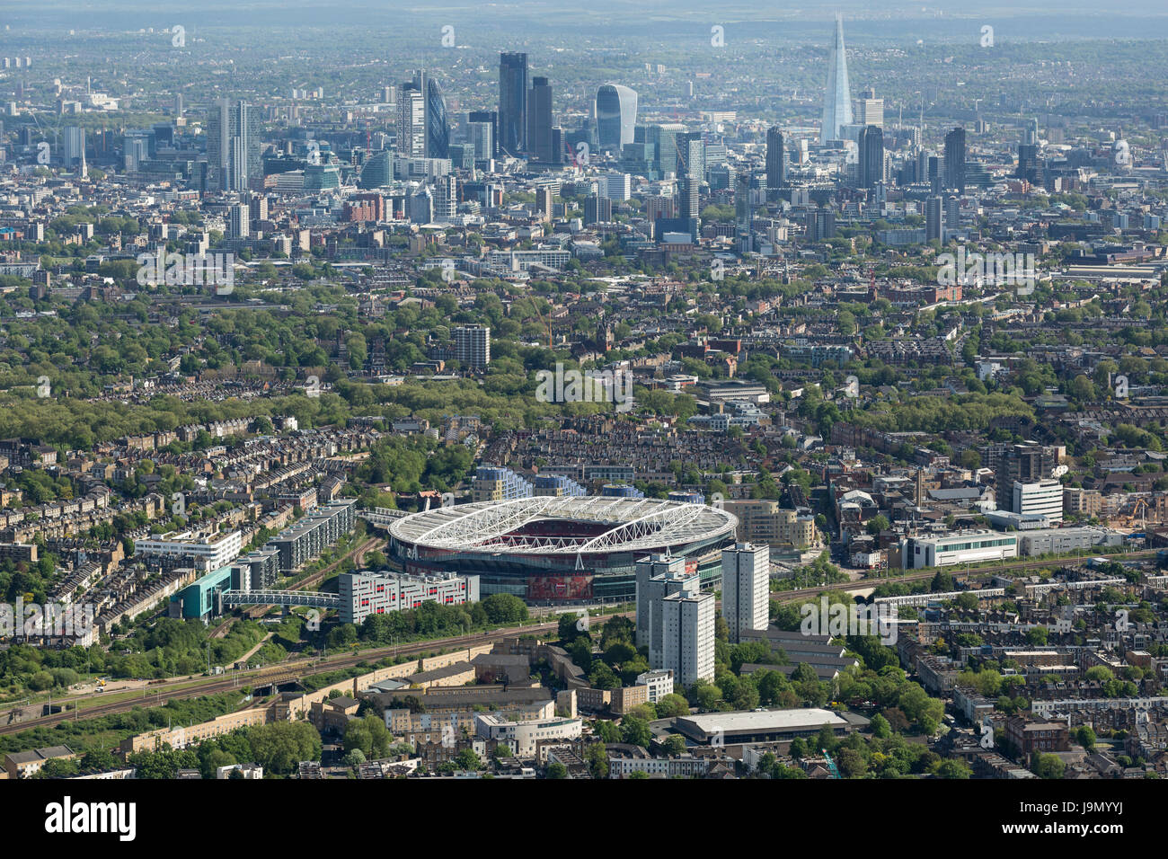 The Emirates Stadium in Highbury, London, England, the home of the Premier Leagues, Arsenal Football Club. Showing the London skyline beyond Stock Photo