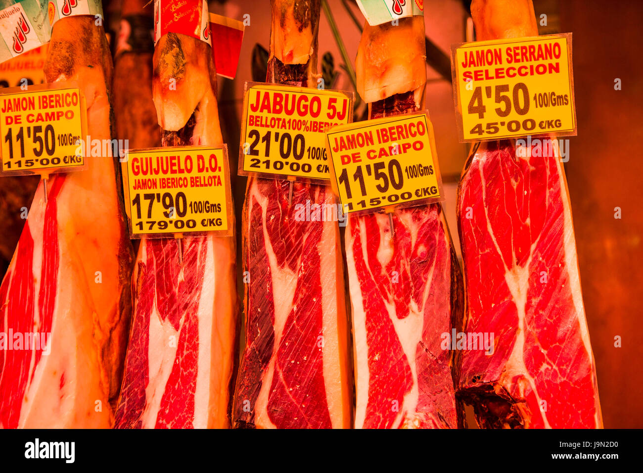 Barcelona's cavernous La Boqueria market is famous for its Jamon Iberico, arguably the world's best tasting ham, named after a black Iberian pig. Stock Photo