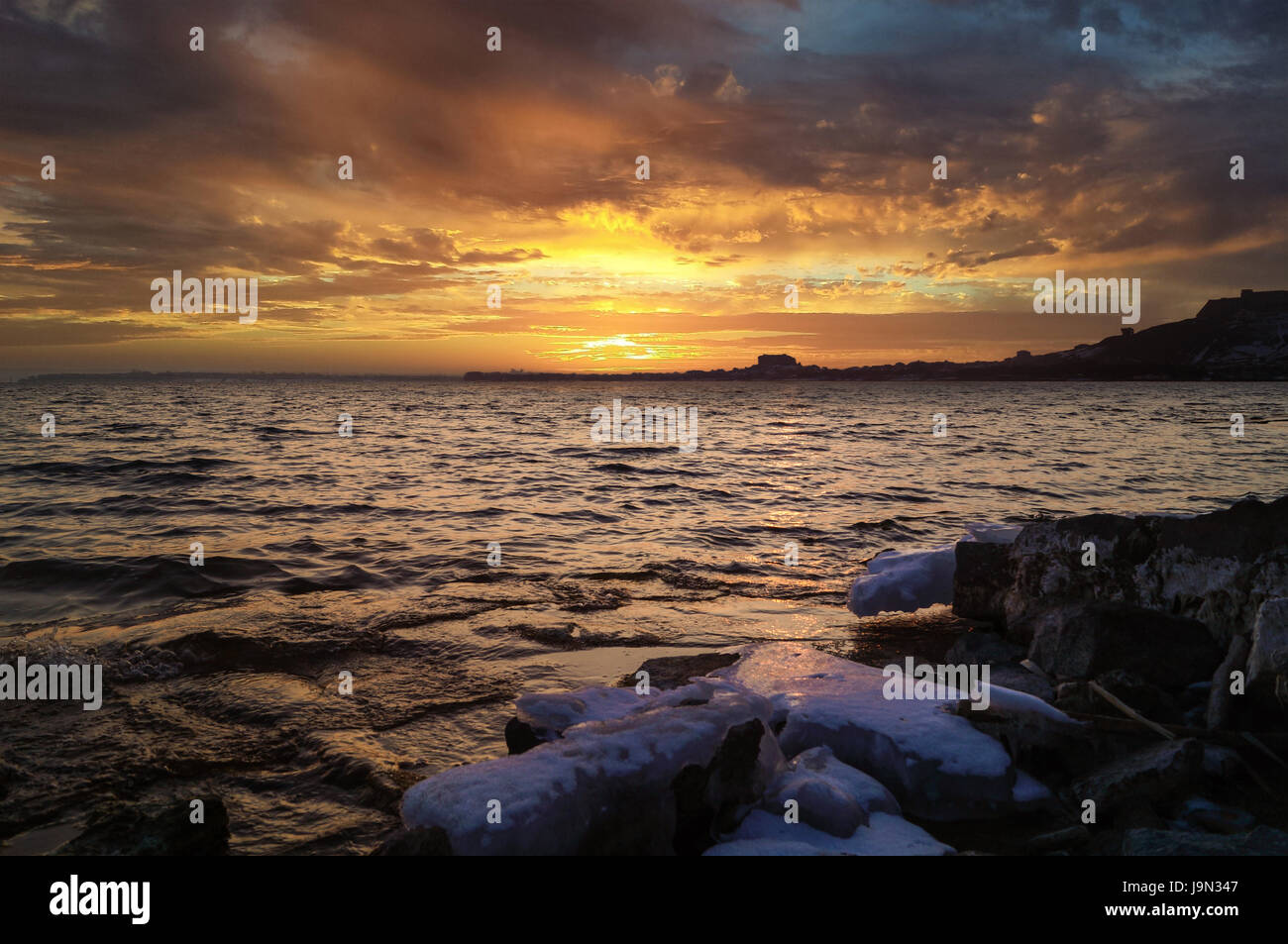 view on Sevan lake sunset in winter day Stock Photo