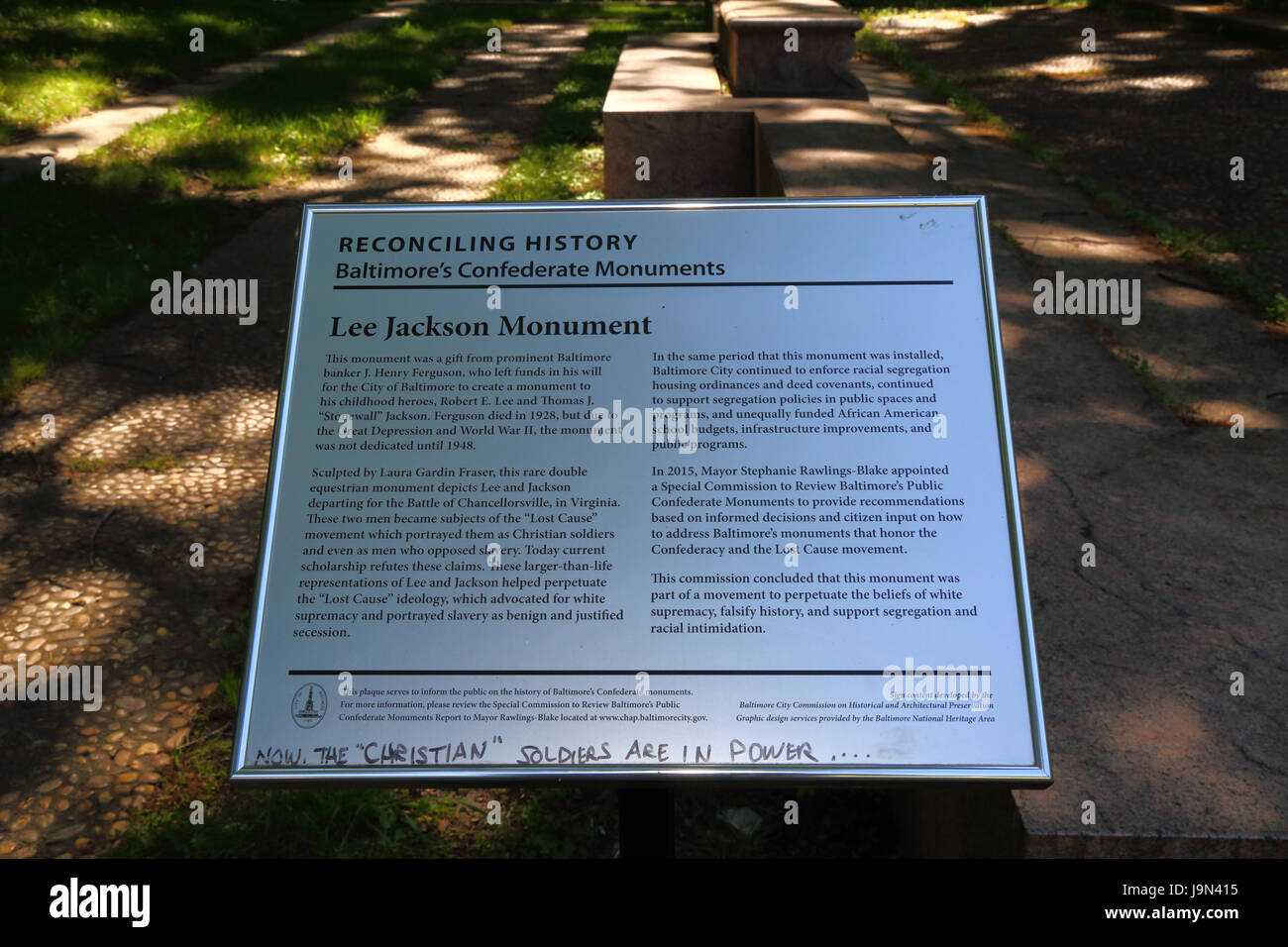 Defaced plaque informing public about the history of the Confederate Army monument to Lee and Jackson,  Wyman Park Dell. Baltimore, Maryland, USA Stock Photo