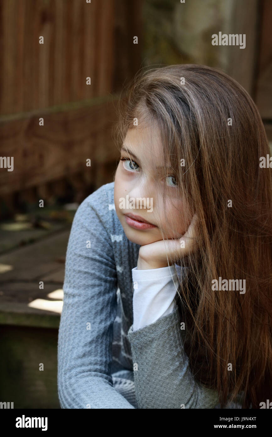 Young girl looking directly into the camera with long flowing hair. Extreme shallow depth of field. Stock Photo