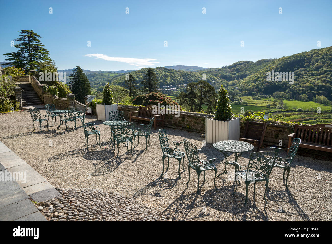 Chairs and tables on the terrace at Plas Tan y Bwlch gardens near Maentwrog in Snowdonia, North Wales, UK. Stock Photo