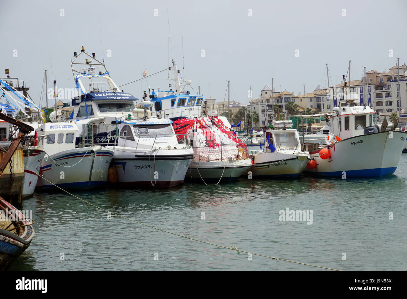 Costa de la Luz Isla Canela  Moral and Cristina fishing boats decorated with ribbons flags and streamers ready to celebrate a Spanish fiesta Stock Photo
