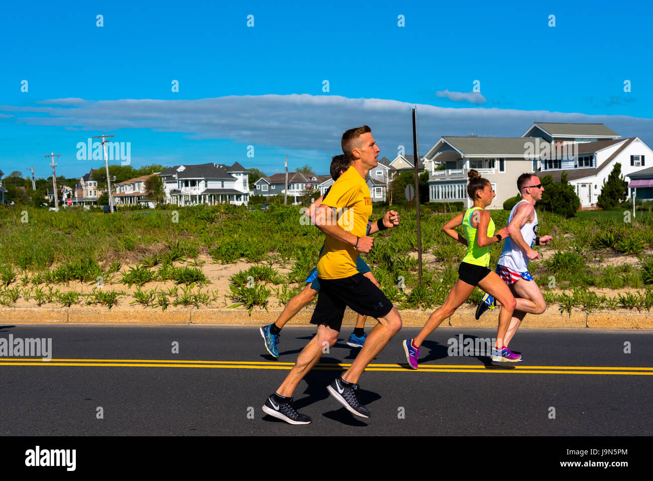 Spring Lake, NJ USA -- May 27, 2017 Runners race down Ocean Avenue in the annual Spring Lake 5 mile Race. Editorial Use Only. Stock Photo