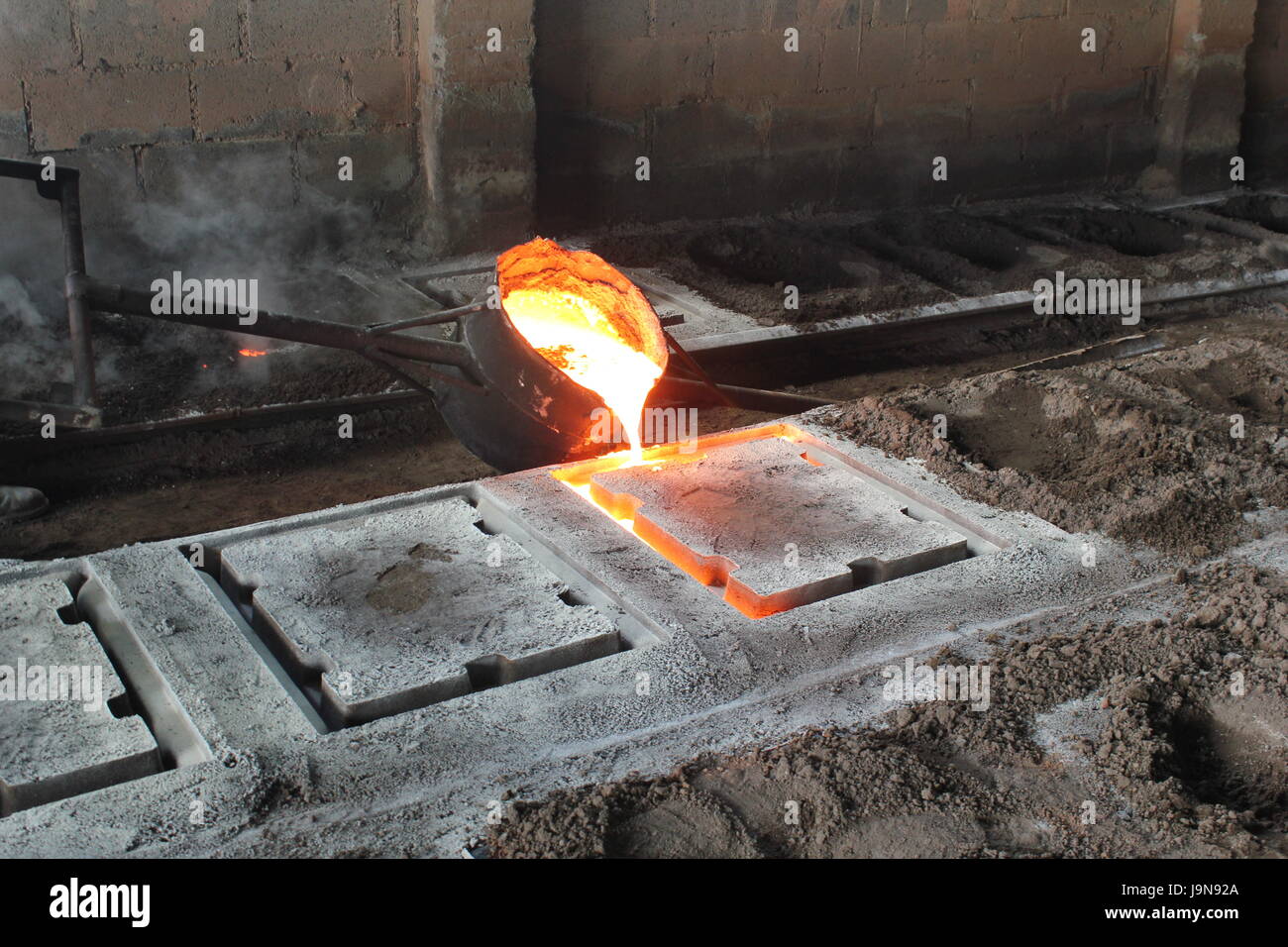 Pouring metal at a foundry in Costa Rica. Stock Photo