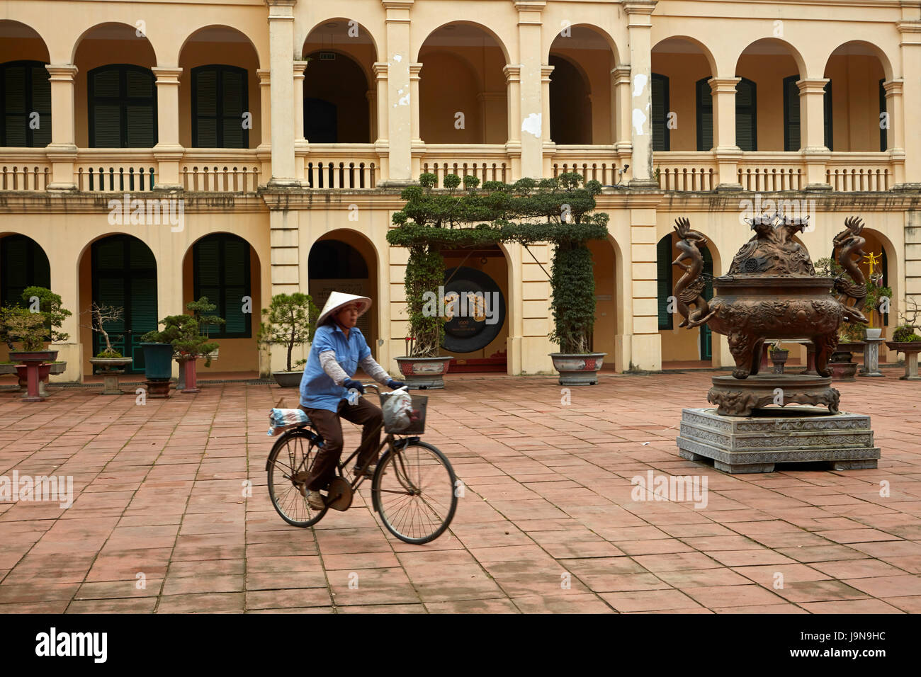 Cyclist and Imperial Citadel of Thang Long (UNESCO World Heritage Site), Hanoi, Vietnam Stock Photo