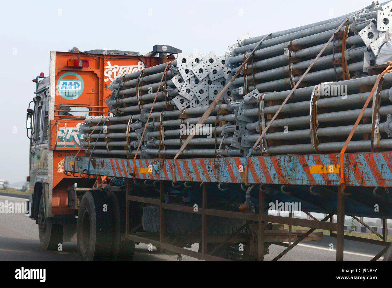 Truck transporting metal steel pillars Stock Photo