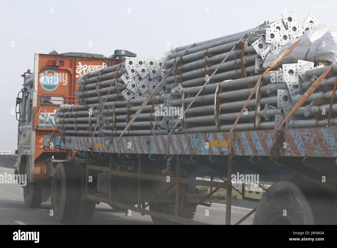Truck transporting metal steel pillars Stock Photo