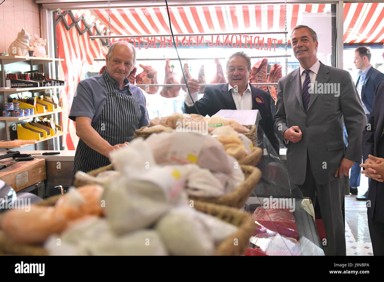 Former Ukip leader Nigel Farage (right) talks to a butcher during a General Election campaign