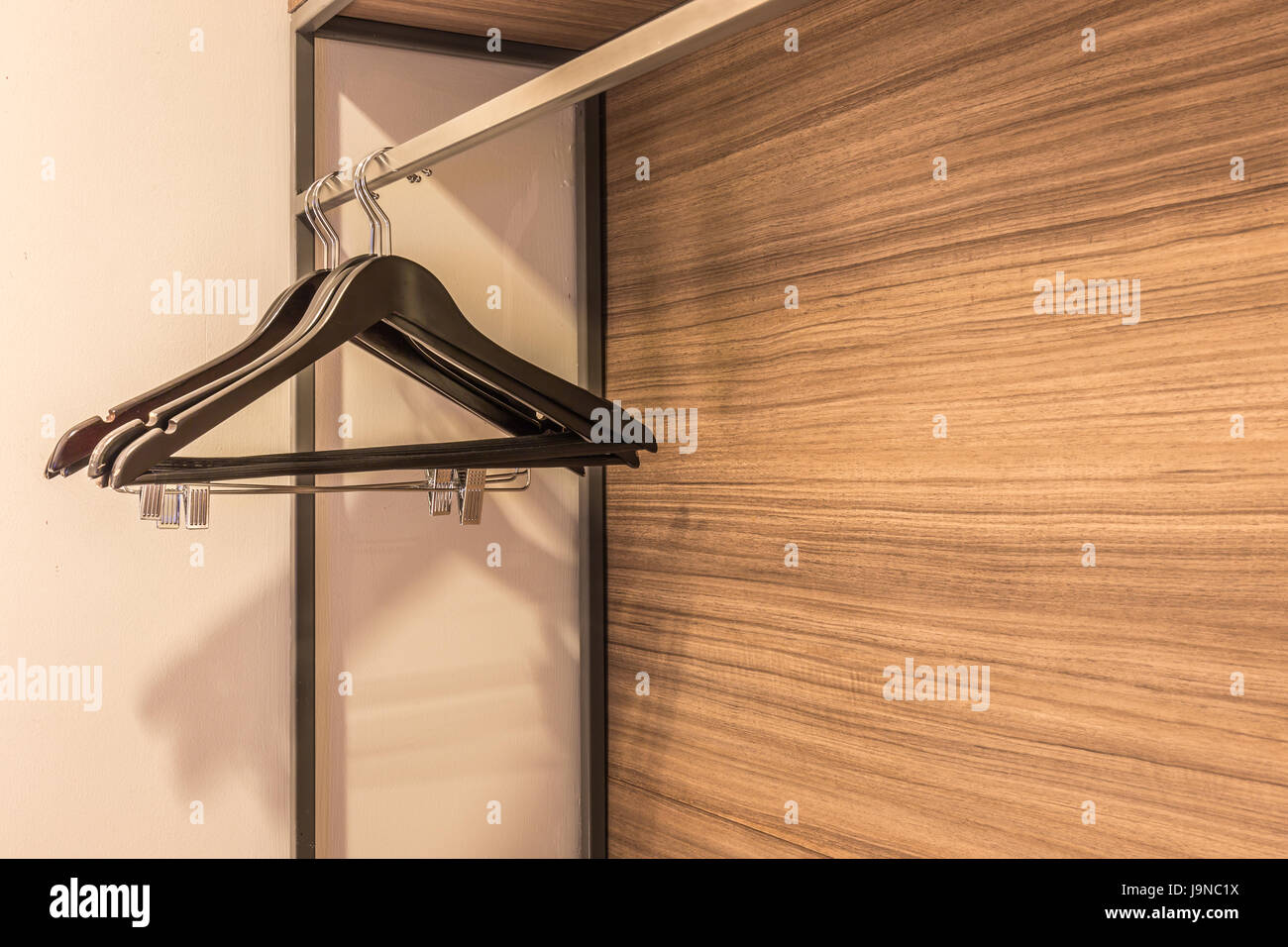 clothes hanger in the wardrobe with warm light Stock Photo