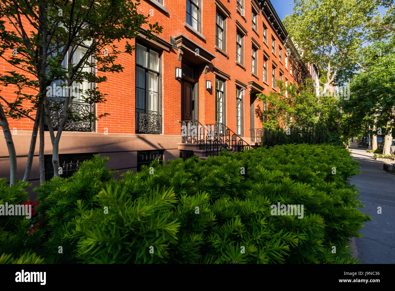century townhouses with brick facades and wrought iron