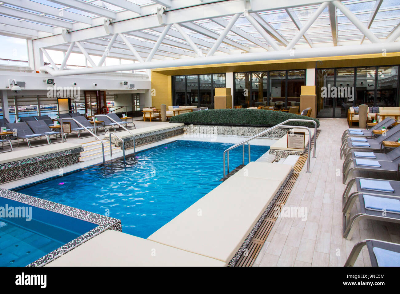 Viking Sea's swimming pool features a retractable roof, making it an all-season venue. Stock Photo