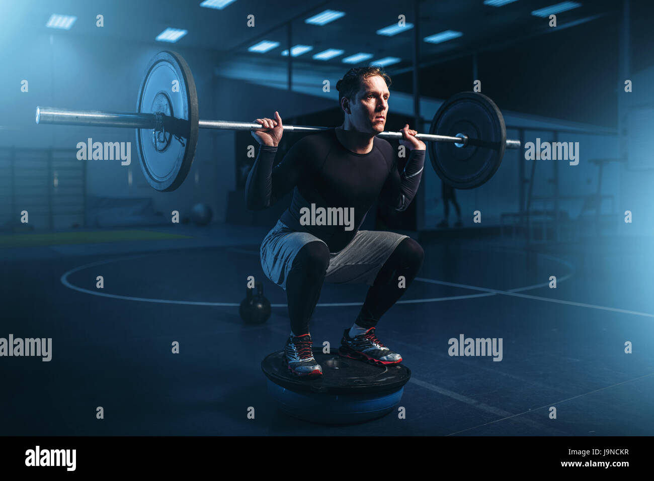 Strength athlete on training, workout with barbell in gym. Active sport ...
