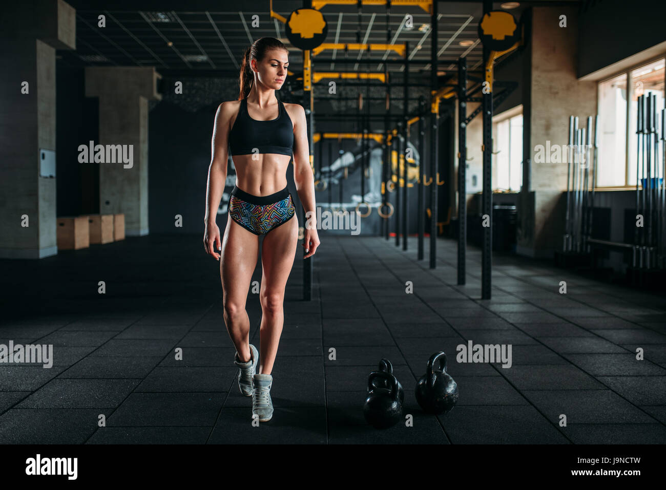 Attractive female athlete with muscular body posing in gym. Slim woman in  fitness club Stock Photo - Alamy