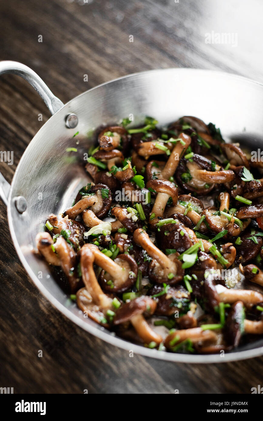 fried shiitake mushrooms in garlic herb and olive oil tapas snack Stock