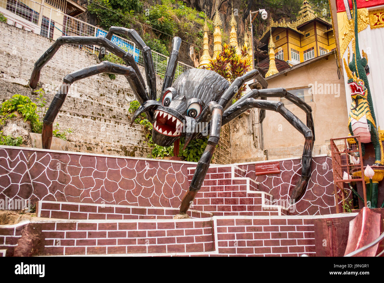 A giant spider in front of the Shwe U Min Pagoda, Myanmar. Stock Photo