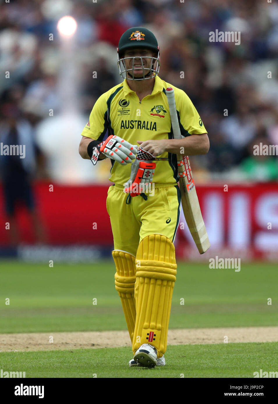 Australia's David Warner walks off after being dismissed by New Zealand's Trent Boult during the ICC Champions Trophy, Group A match at Edgbaston, Birmingham. Stock Photo